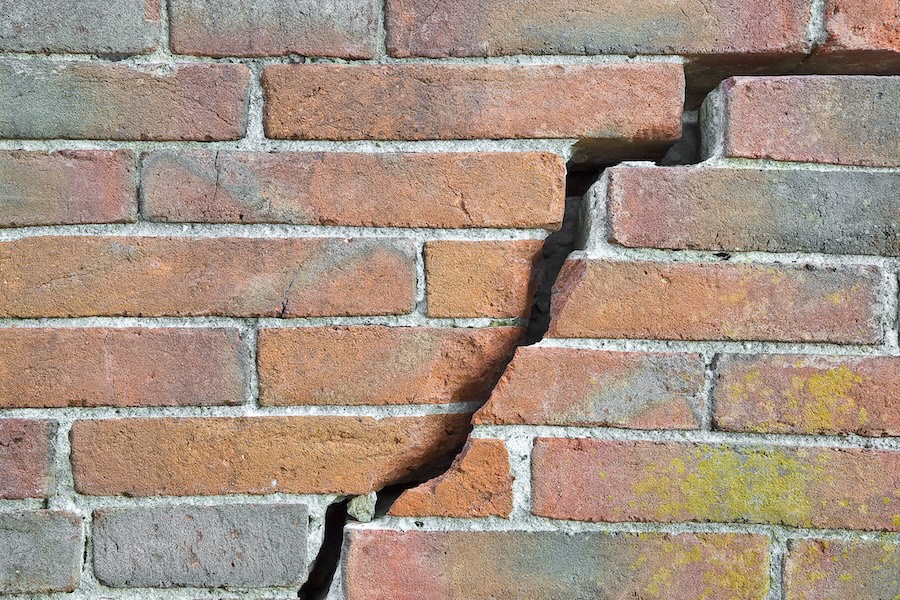 Dangerous old exposed cracked brick wall due to structural foundation failure