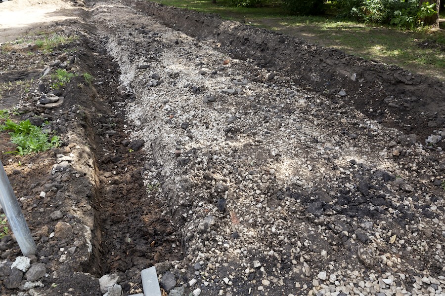 A french drain tunnel dug into gravel